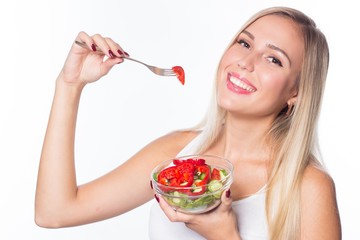 Young beautiful woman eats vegetable salad. Healthy eating. To be in shape.