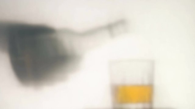 Man pours whiskey over white background