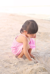 Portrait Kid girl playing sand at the beach