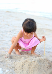 Portrait Kid girl playing sand at the beach