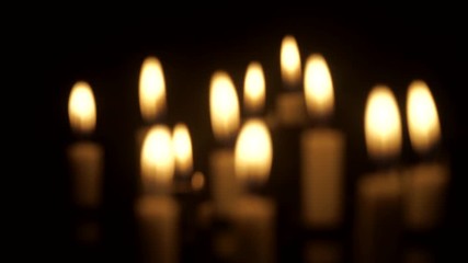 Video footage of golden light of Easter candles burning in the church at night