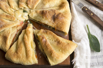 puff pastry pie with spinach on a wooden Board