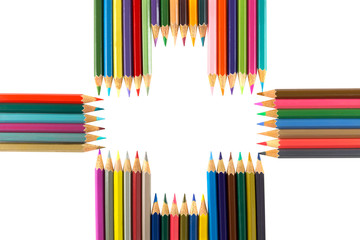 Variety of colored pencils arranged as a Plus sign, isolated on white background, conceptual photo for positivity