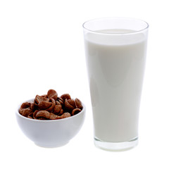 glass of milk and cereals in white bowl on white background