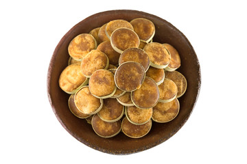Clay bowl full of Jaggery sugar made of Asian Palmyra Palm sap filled in slices of small dried palm...
