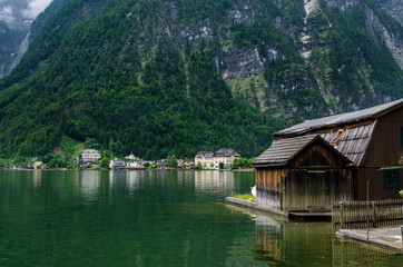 Fototapeta na wymiar Pier and house on the Hallstaettersee lake. Hallstatt, Salzkammergut region, Austria