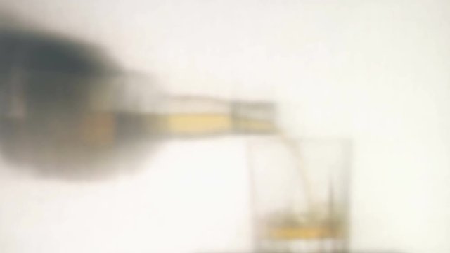Man pours whiskey over white background