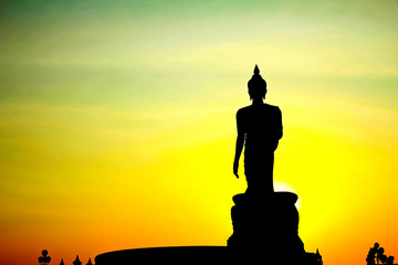 Sunset in Buddhist park in the Phutthamonthon district, Buddhamonthon. Nakhon Pathom Province of Thailand. (Silhouette of Buddha)