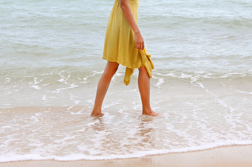 Young woman walking alone on the beach