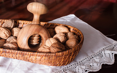 walnuts and nutcracker in a basket with tableclothe 