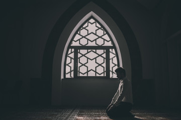 Muslim praying in a building with perfect background