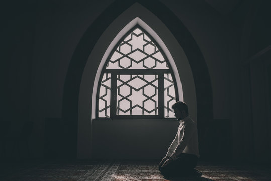 Muslim praying in a building with perfect background