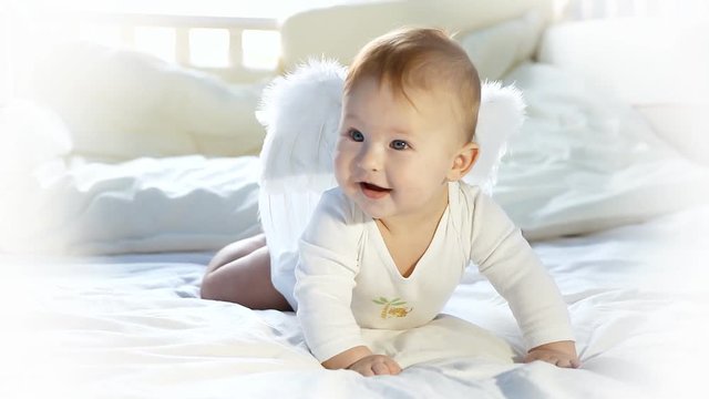 Baby angel fun on the bed 