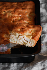 Close-up of a slice of apple pie on a knife. Vertical shot.