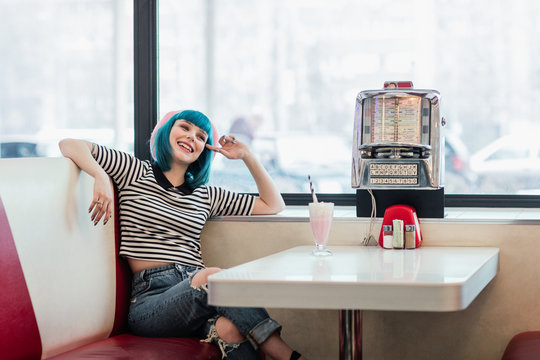 Styish Pin Up Woman Sitting at Vintage Resturant