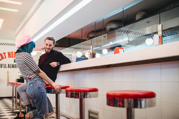 Couple Having Fun in Vintage Diner Bar