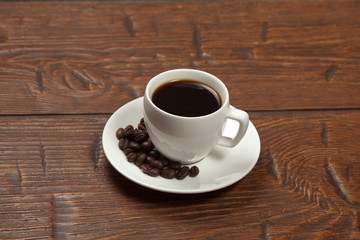 White cup of coffee with beans