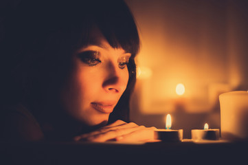 woman in bathtub with candles