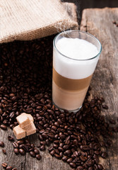 Coffee on a wooden table. Dark background.