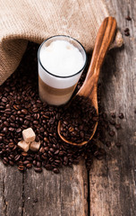 Coffee on a wooden table. Dark background.