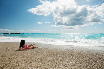 Fototapeta na wymiar Young fashion woman relax on the beach