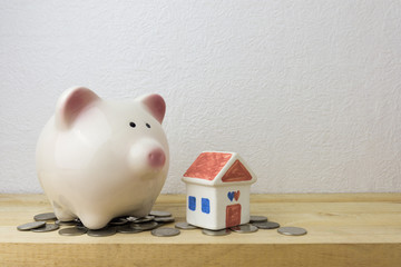 piggy bank with house and coins