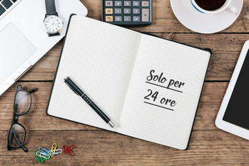 Solo per 24 ore, Italian text for Only 24 Hours in notebook on office desk with computer technology, high angle