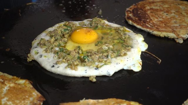 Preparing egg bara, a traditional Newari snack made of black lentil
