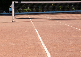 Fototapeta premium Orange brown sand empty private tennis court ready for game