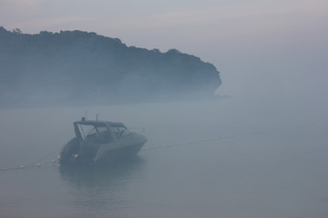 Blurred speed boat in the fog-covered sea.  