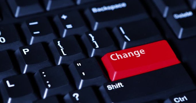 Close up of a male finger pressing a red Change button on the computer keyboard