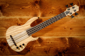 micro bass guitar on wooden background
