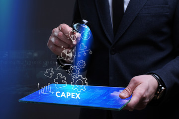 Business, Technology, Internet and network concept. Young businessman working on a virtual screen of the future and sees the inscription: Capex