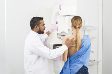 Doctor Standing Assisting Patient Undergoing Mammogram X-ray Tes