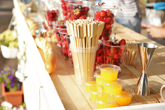 Fresh tasty berries with honey on wooden table
