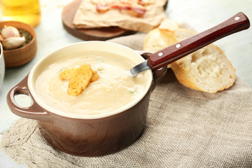 Delicious cream soup with bread on table