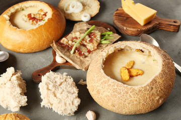 Delicious cream soup in bread on table