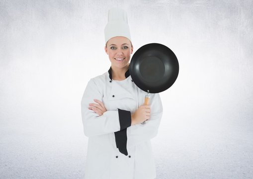 Chef with frying pan against white background