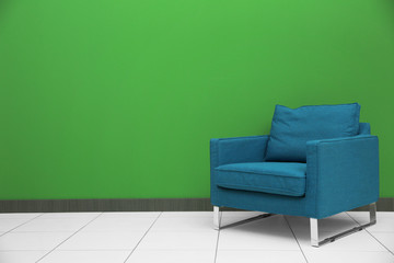 Armchair on color wall background