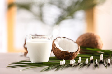 Composition with fresh coconut milk on table against blurred background