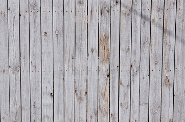 Wooden fence from fading boards