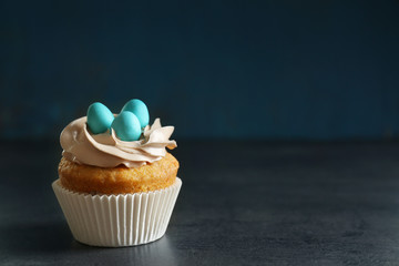 Delicious Easter cupcake on dark background