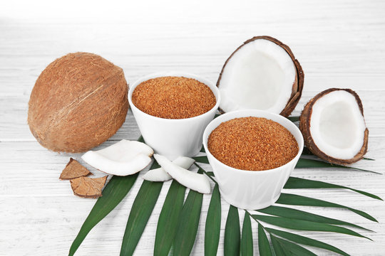 Bowls of coconut sugar on wooden background
