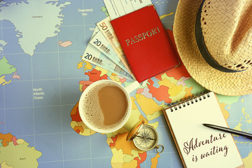 Traveller's accessories on world map background, top view. Travel planning concept