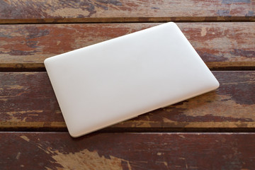 Workplace, laptop on a wooden desk.