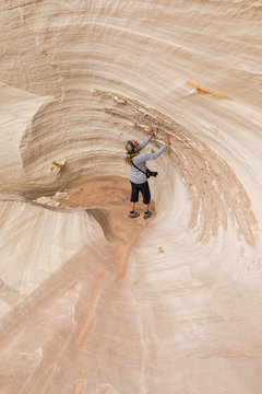 USA, Paria Canyon, Vermillion Cliffs, Page, tourist inside rock formation Nautilus