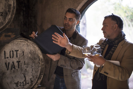 People in distillery tasting whiskey