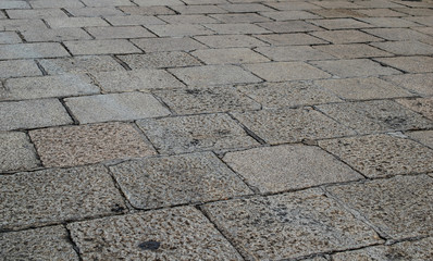 Obraz premium Ancient stone pavement, oled square rock floor.