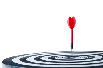 Close up shot red dart arrow on center of dartboard Isolated on white background
