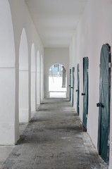 Corridor with arches, iron and wood doors